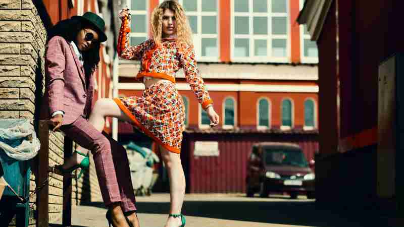 Stylish women posing in an urban alley showcasing contemporary fashion trends., tags: und - pexel